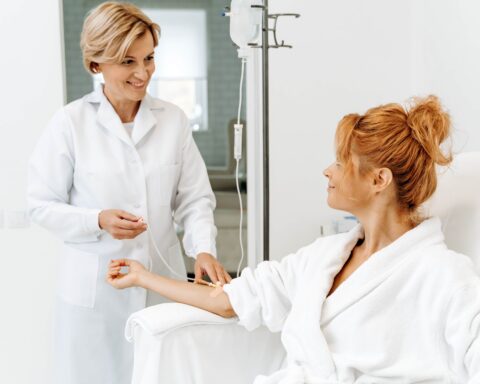 An image of a woman receiving cellular reprogramming therapy via intravenous drip.