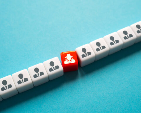 A row of white cubes with icons of people in suits, symbolizing uniform individuals, with a single red cube depicting a figure in a hat and trench coat, representing an undercover or hidden character among the crowd. This visually highlights the concept of an infiltrator or hidden element within a larger group, akin to the role of cancer-associated fibroblasts (CAFs) supporting tumor growth in the tumor microenvironment.