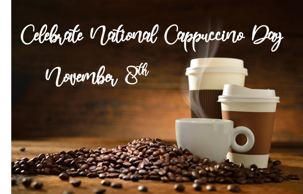 Celebrate National Cappuccino Day on November 8th. A cozy arrangement of a steaming white coffee cup and two to-go coffee cups surrounded by coffee beans, set against a warm, rustic wooden background.