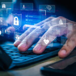 Close-up of hands typing on a keyboard with a digital overlay of health-related icons like DNA, a heart, and a brain, representing the role of DNA methylation research in decoding and potentially reversing the aging process.