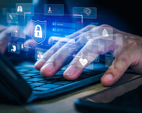 Close-up of hands typing on a keyboard with a digital overlay of health-related icons like DNA, a heart, and a brain, representing the role of DNA methylation research in decoding and potentially reversing the aging process.