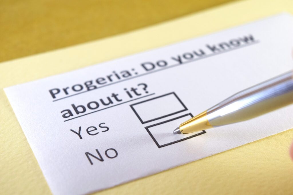 An image of a questionaire with a single question, asking "Progeria: Do you know about it? There are two boxes for "Yes" and "No" with a pen hovering over the "No" box.