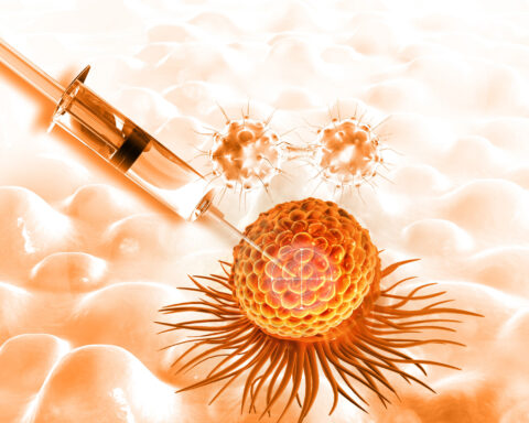 An image of a syringe targeting a cancer cell on an orange background. Two cancer cells are in the background about to be targeted by the new immunotherapy.