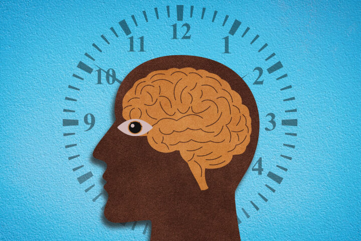 A stylized illustration of a human head in profile, the silhouette dark and textured like cut paper, with an amber brain sketched inside. An eye peers outward, open and alert, while behind the head a clock face radiates, its numbers and tick marks encircling the figure against a bright blue backdrop. The composition evokes the relentless cadence of time interwoven with cognition and the biological rhythms that govern human aging.