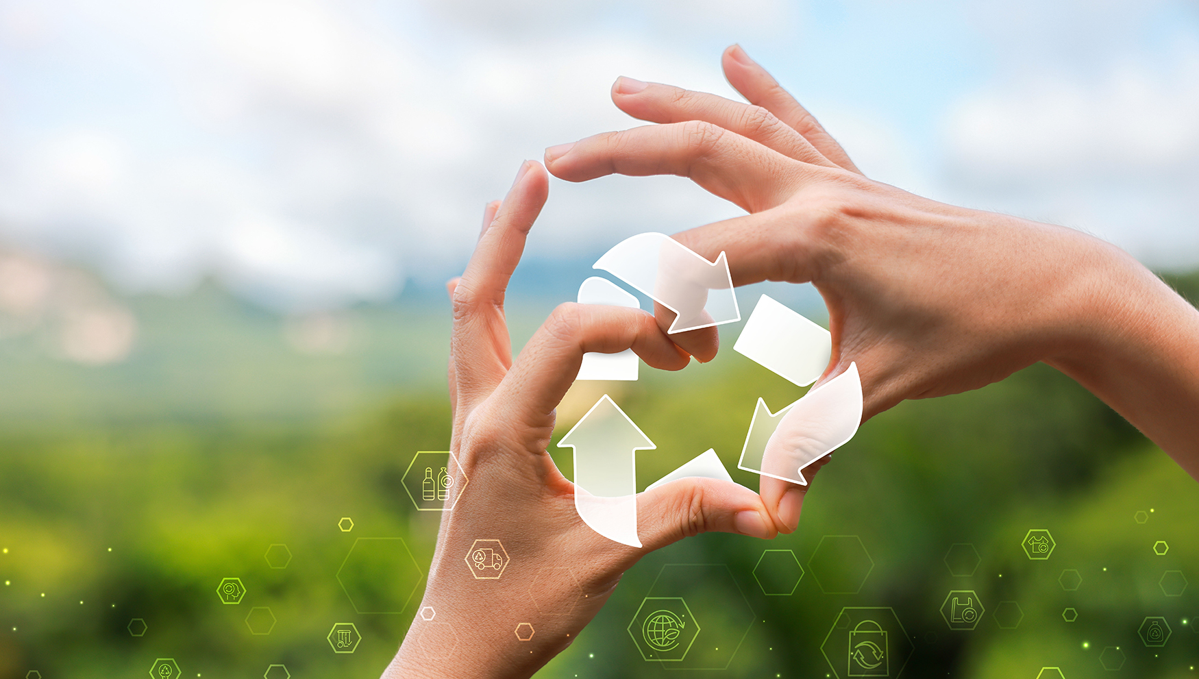 Two hands form a circle against a blurred green landscape, framing a translucent set of recycling arrows that symbolize renewal and continuous cycles of life. Subtle glowing hexagons with icons for health, sustainability, and science float across the foreground, blending natural imagery with futuristic design to evoke the concept of cellular recycling and longevity.