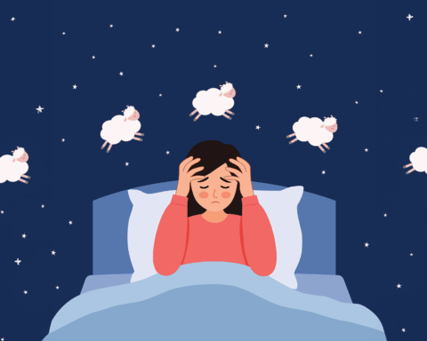 A sleepless person sits upright in bed with hands gently pressed to their temples, eyes tired and face drawn with exhaustion. Soft cartoon sheep float across a deep blue night sky scattered with tiny stars, suggesting the familiar struggle of counting sheep that offers no relief. The scene conveys the quiet frustration and emotional weight of insomnia, capturing the intimate moment when the mind refuses to rest even as the world around grows still.