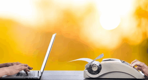 A side-by-side scene showing hands typing on a modern laptop on the left and hands using a vintage typewriter on the right, set against a warm, glowing yellow background, symbolizing the contrast between old and new approaches.