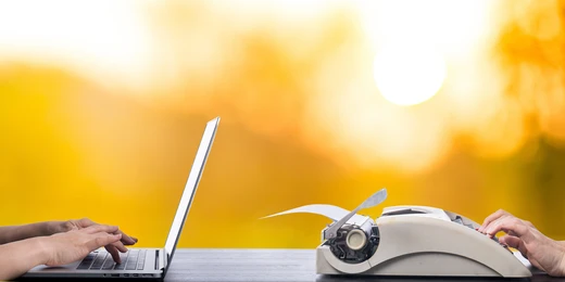 A side-by-side scene showing hands typing on a modern laptop on the left and hands using a vintage typewriter on the right, set against a warm, glowing yellow background, symbolizing the contrast between old and new approaches.